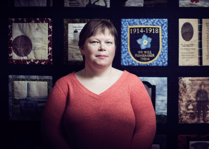 Tracy Madore in front of the quilts commemorating the First World War