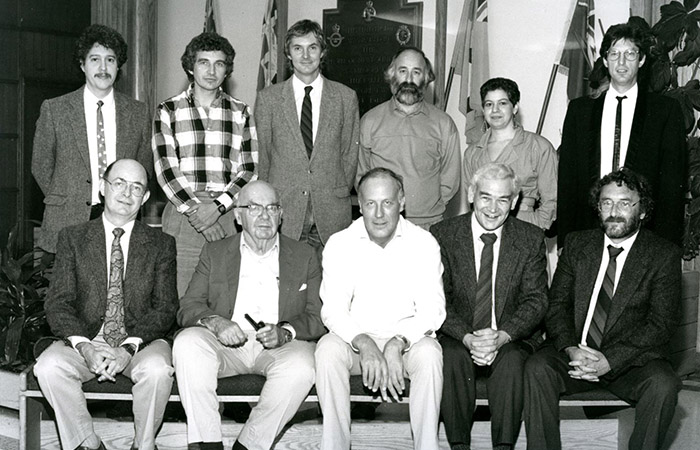 Department of Folklore faculty members in 1987: Standing (L-R) Dr. Peter Narvaez, Dr. W.W. Wareham (BA(Ed.)’71, BA’73), Dr. Martin Lovelace
(MA’76, PhD’84), Dr. L.G. Small, Dr. D. Goldstein, Dr. Gerald Pocius (B.Sc.’73, MA’76). Seated (L-R): Dr. N.V. Rosenberg (Director, MUNFLA), Dr. Herbert
Halpert (Professor Emeritus), Dr. John Widdowson (PhD’73, D.Litt.’00) (Honorary Research Associate), Dr. D. Buchan (University Research Professor), Dr.
G. Thomas (Department Head). Missing from photo: Dr. J. Ashton.PHOTO: PHOTOGRAPHIC SERVICES, UNIVERSITY RELATIONS