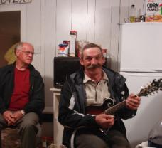 Casey House. Gerard Chaytor plays for a kitchen party in the Casey House Artist Residency, Conche, Newfoundland