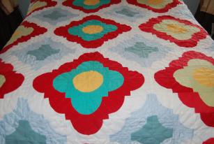 Wilcox, Naomi. A yellow and red patchwork quilt made by Naomi Wilcox, Roddickton