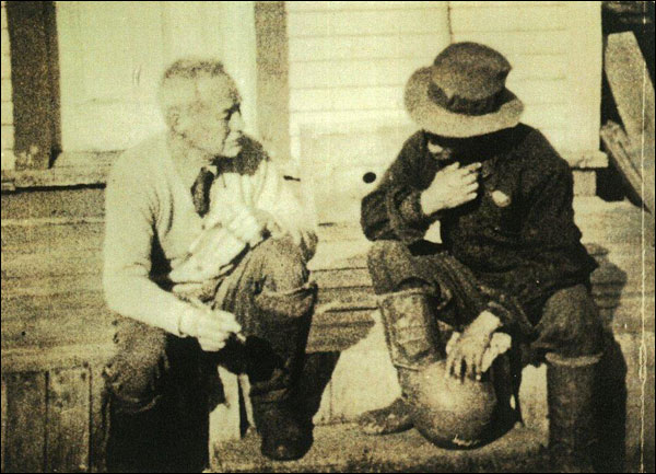 Dr. Grenfell chats with a football player on the hospital steps at Spotted Island, ca. 1932