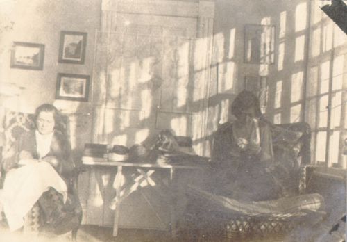 two women relaxing and doing needlework