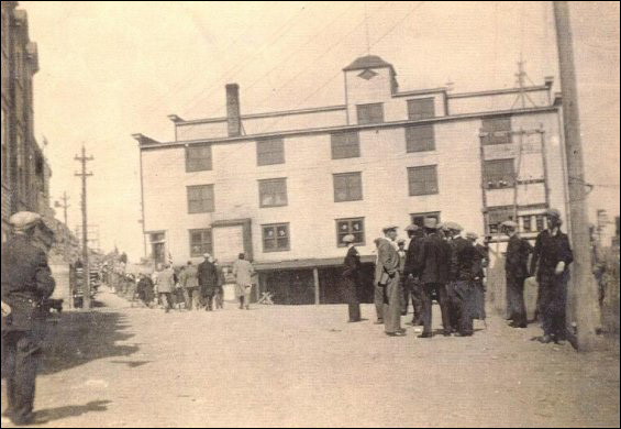 Parade day at Port Union with eastern facade of the Fishermen's Union Trading Company store in background.