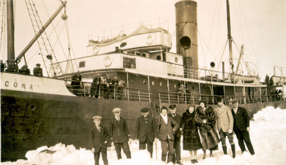 Seven men and two women standing near the S.S. "Sagona"