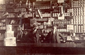 Two men standing at a counter inside a grocery store