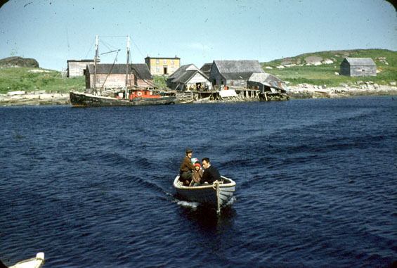 Reuben Mesher and two others in a small boat at Cartwright, Labrador