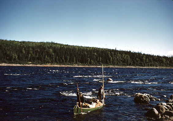 Harold Baikie and Russell Groves canoe poling in a river in Labrador