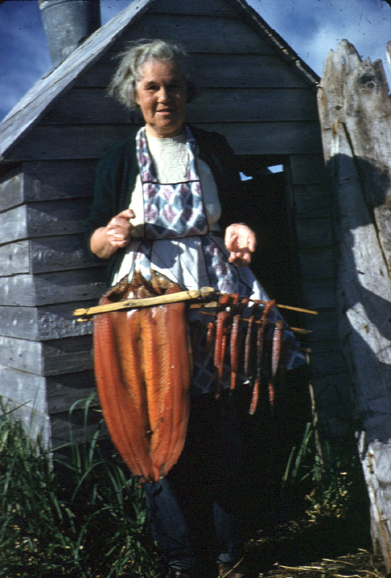 A woman named Aunt Lizzie holding smoked fish in Labrador