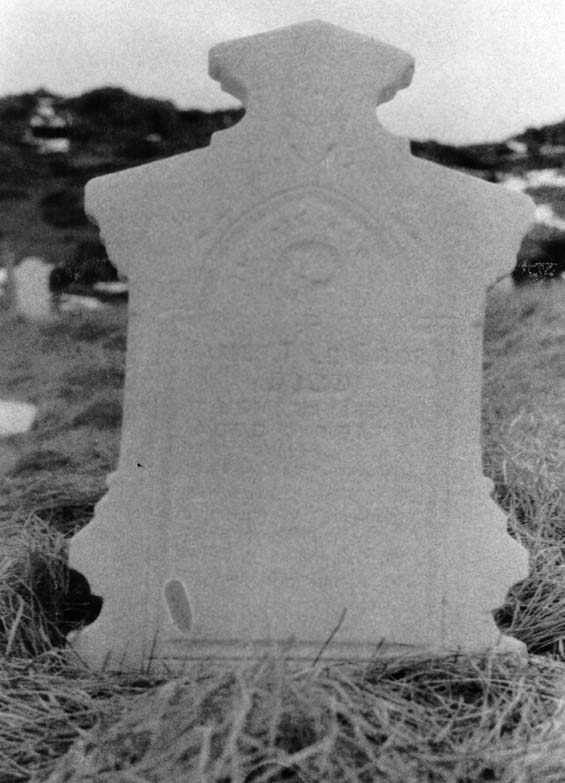 Faded headstone of James T. LeGros at the cemetery in Exploits, Newfoundland