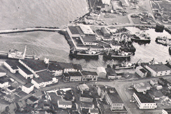 Aerial view of Grand Bank, Newfoundland, showing Water Street, Bonavista Cold Storage Co. Ltd. plant, and trawlers