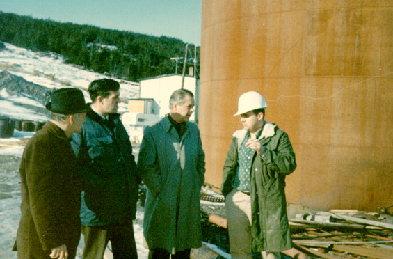 Spencer G. Lake (third from left) with three unidentified men standing outside a fish plant Newfoundland