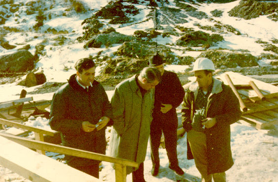 Spencer G. Lake (second from left) and three unidentified men standing outside a fish plant in Newfoundland