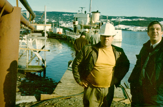 Unidentified men standing outside a fish plant in Newfoundland
