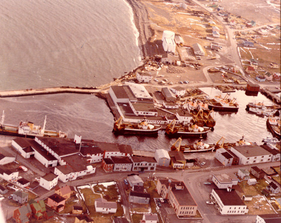Aerial view of Grand Bank, Newfoundland, showing Water Street, Bonavista Cold Storage Co. Ltd. plant, and trawlers
