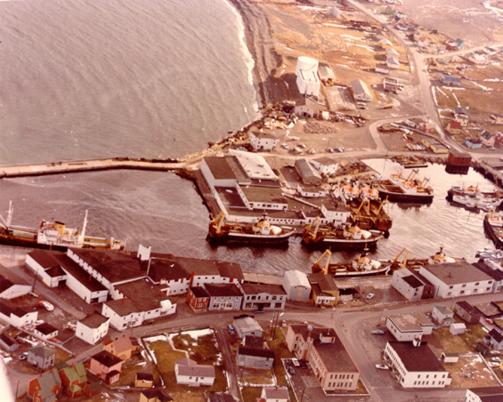 Aerial view of Grand Bank, Newfoundland, showing Water Street, Bonavista Cold Storage Co. Ltd. plant and trawlers