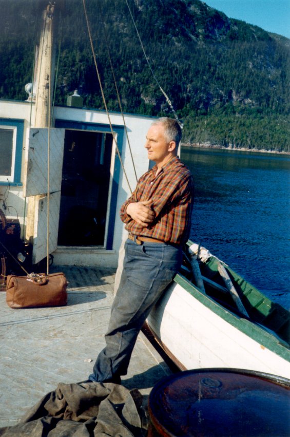 Unidentified man standing on a fishing boat at Englee, Great Northern Peninsula, Newfoundland
