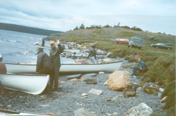 Men pulling their motorboats up on the rocky beach, somewhere in Newfoundland