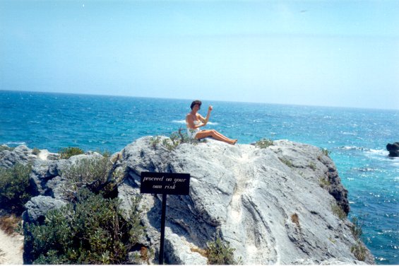 Harold L. Lake's wife, Robin, sitting on a large rock in St. George, Bermuda during a vacation