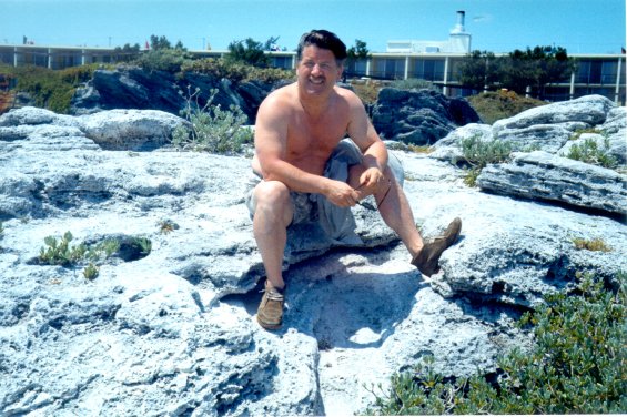 Harold L. Lake sitting on a large rock in St. George, Bermuda during a vacation