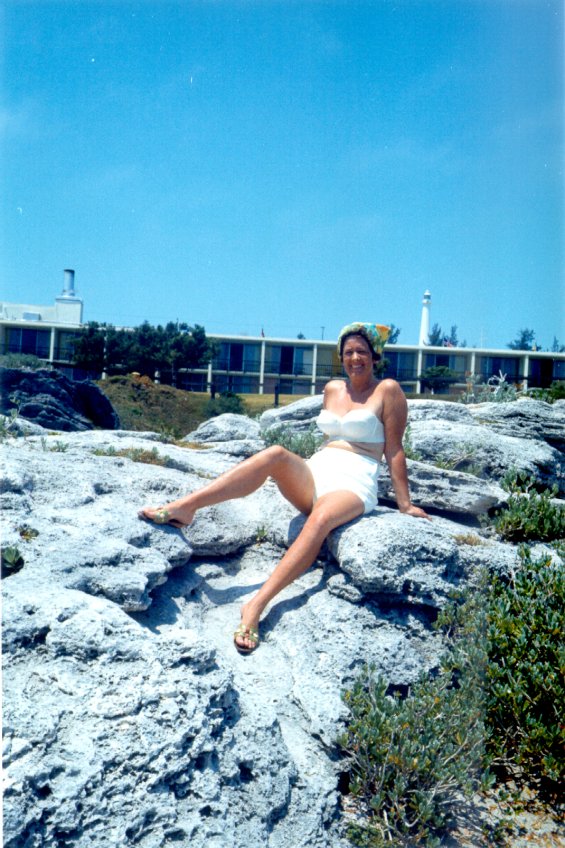 Harold L. Lake's wife, Robin, sitting on a large rock in St. George, Bermuda during a vacation