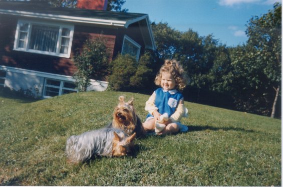 Harold L. Lake's daughter with her Yorkshire Terriers in front of the Lake family home known as 