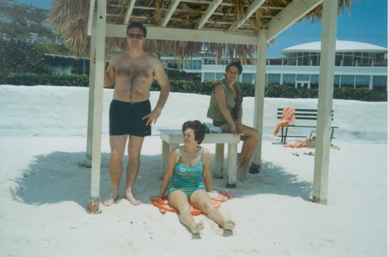Harold L. Lake's wife, Robin, sitting on a sandy beach in St. George, Bermuda, during a vacation
