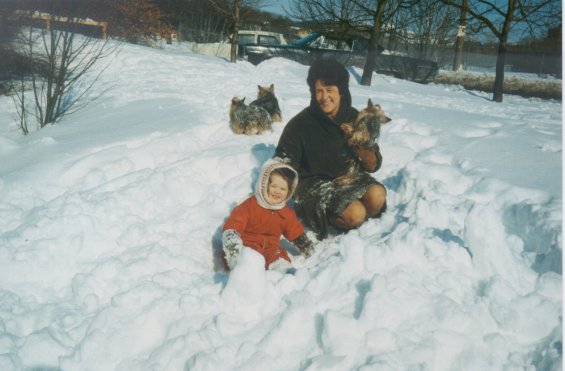 Harold L. Lake's wife, Robin, and their daughter playing in the snow with their Yorkshire Terriers