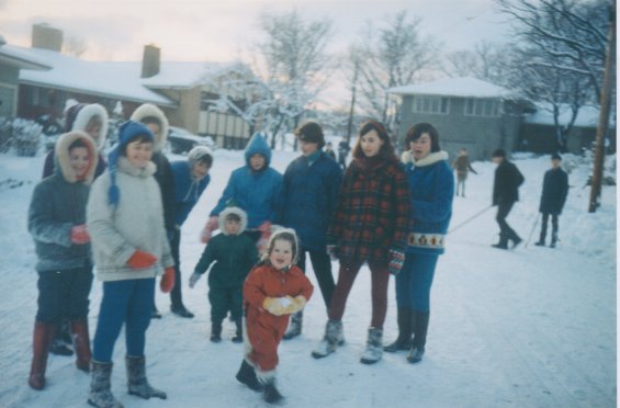 Harold L. Lake's daughter (centre in red suit) amongst a group of children outside in the snow