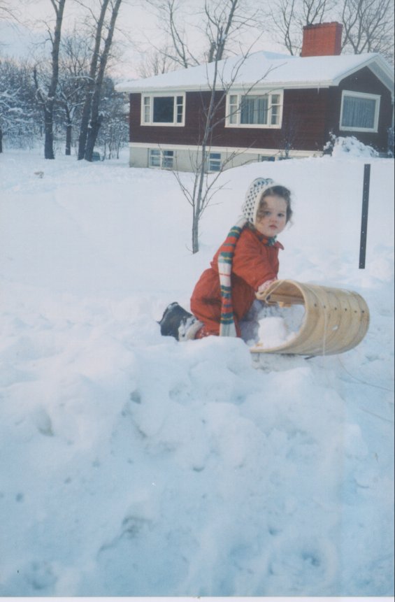 Harold L. Lake's daughter playing in the snow outside of the Lake family home known as 