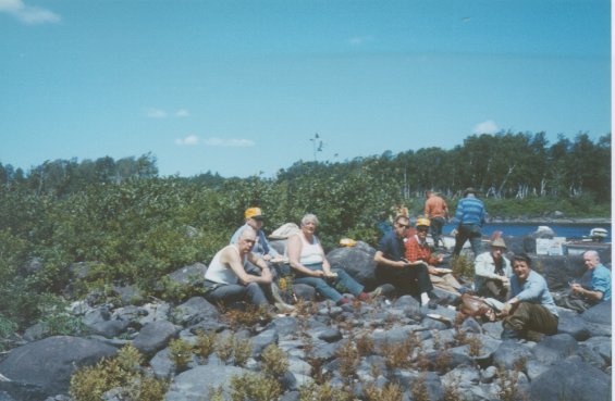 Harold L. Lake (second from right) with a group of people on a rocky beach