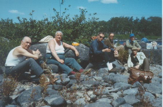 Group of people on a rocky beach during a fishing trip with Harold L. Lake (not pictured)