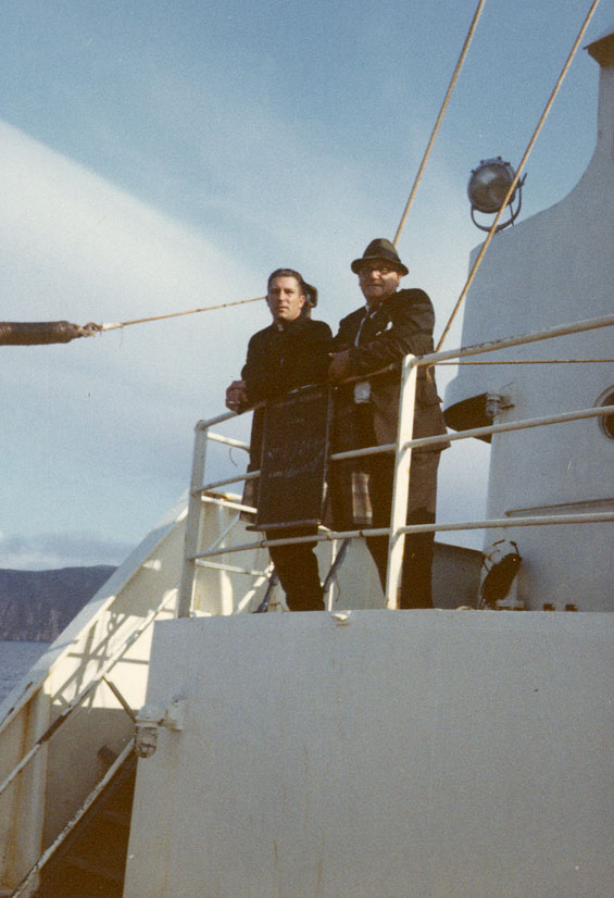Two people standing on an unidentified ship