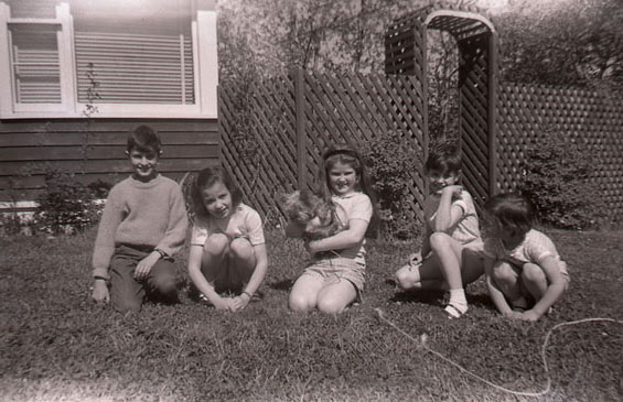 Group of children sitting on Harold L. Lake's lawn