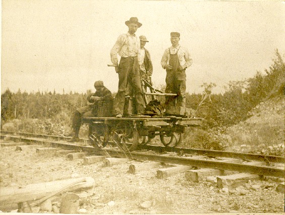 Foreman Billy Best and sectionmen on a railway pump car somewhere in Newfoundland