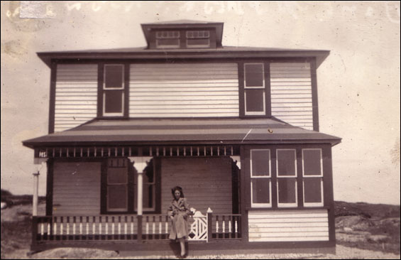 Minnie Feltham in front of a house built by Bert Feltham but never lived in. Later taken down to build a 'store'