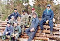Leeland Masters, Roy Wareham (2nd & 3rd, in front) and friends cutting sticks to build a wharf for the reunion at Harbour Buffett.