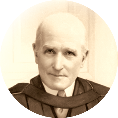 A black and white photograph of John Lewis Paton in academic robes