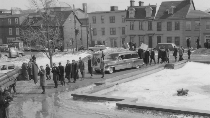 A photo of Memorial students marching to the Colonial Building