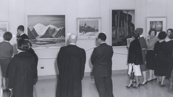Patrons admire the art on display at the opening of the university art gallery