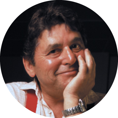 A headshot of Dr. Elliott Leyton smiling with his hand on his face