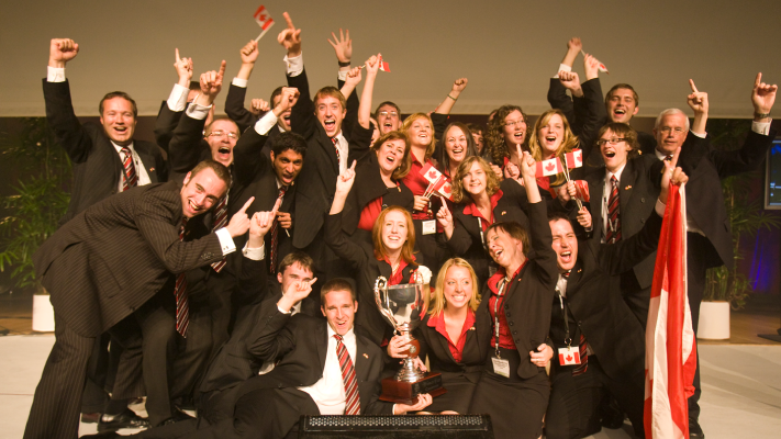 A group photo of Enactus Memorial student with the award for the first Enactus World Cup.