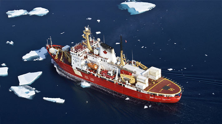 An aerial photograph of a Canadian Coast Guard vessel in icy open water