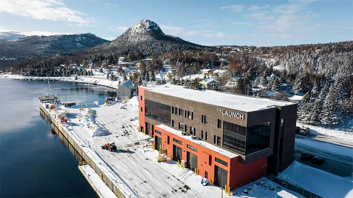 An overhead shot of a building next to the ocean called The Launch that is a marine living lab