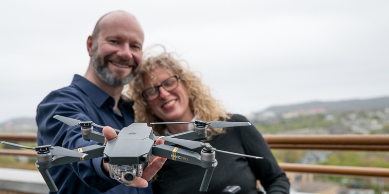 Researchers holding a remote control drone
