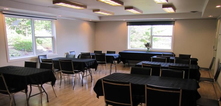 Conference room with tables set up, with black table cloths