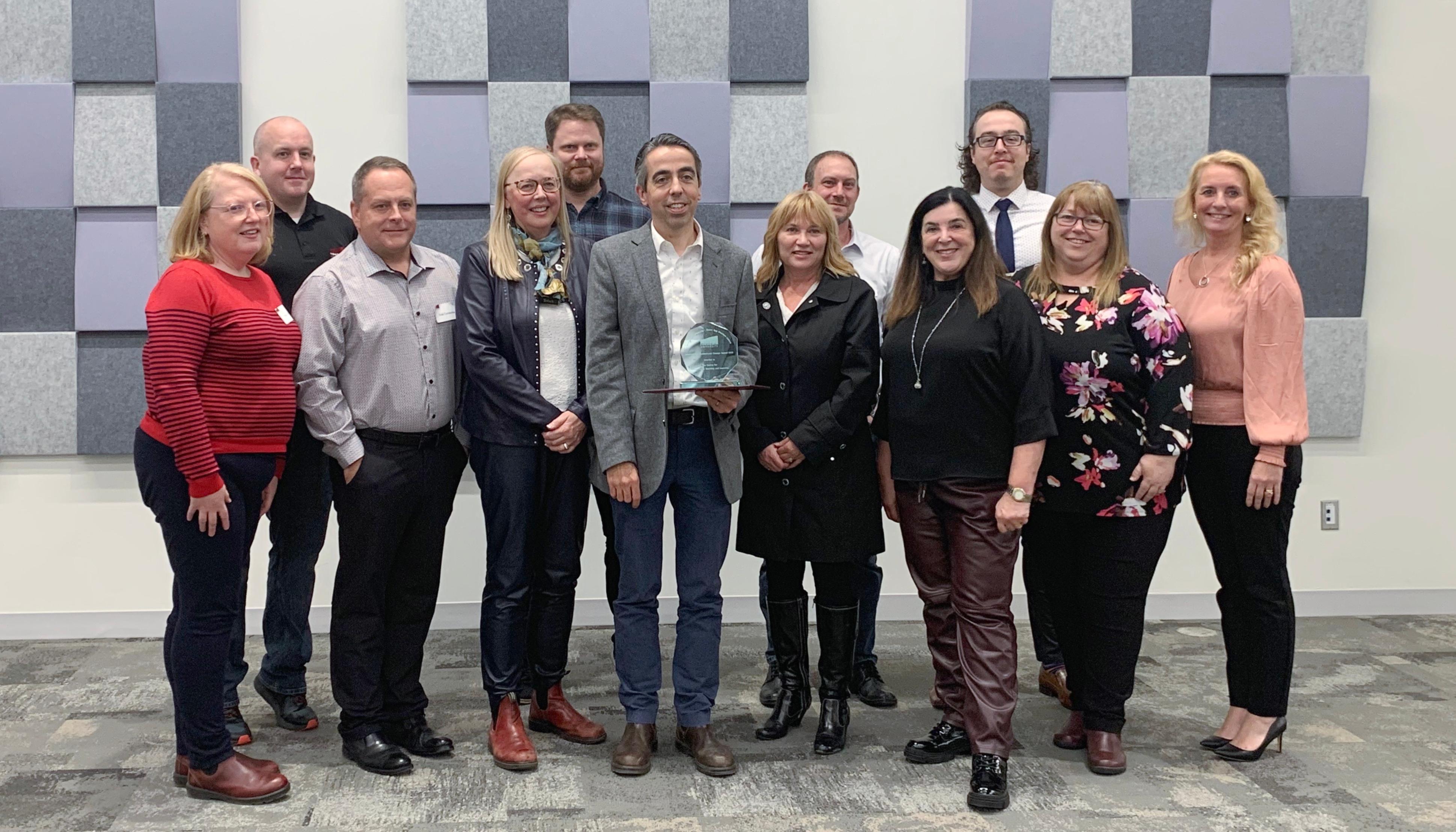 A selection of CITL staff stand with Drs. Donna Hardy-Cox and Vianne Timmons at the award ceremony.