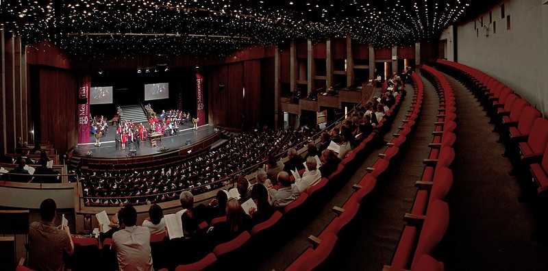 studentsand parents fill the auditorium for the Convocation ceremony. The stage is set up for convocation.