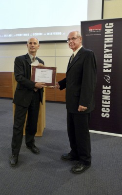 Dr. Jeremy Hall receiving award