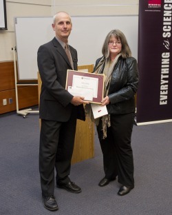 Dr. Mark Abrahams, Dean of Science, presenting the Distinguished Service Award to Roberta (Robbie) Hicks of the Department of Earth Sciences