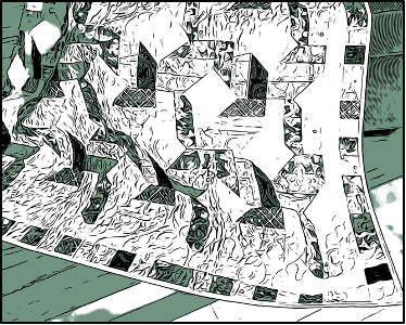 A handmade quilt is draped across a sunny floor.